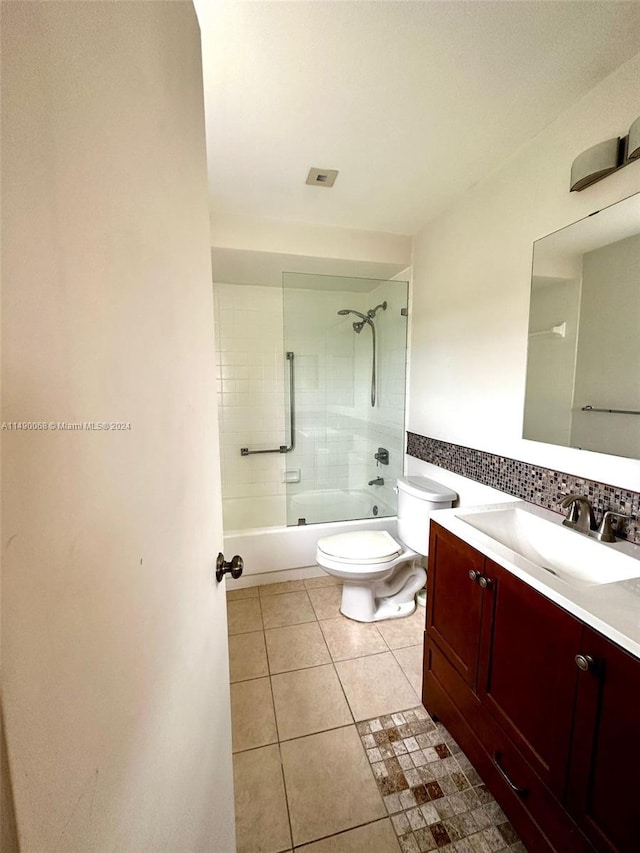 full bathroom featuring toilet, tiled shower / bath combo, tile patterned flooring, and vanity