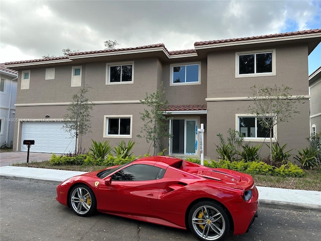 mediterranean / spanish-style house featuring a garage