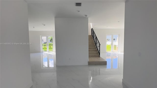 staircase featuring light tile flooring and plenty of natural light