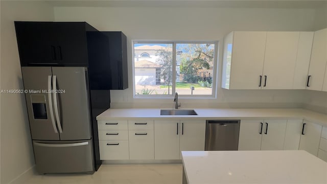 kitchen featuring white cabinetry, appliances with stainless steel finishes, and sink