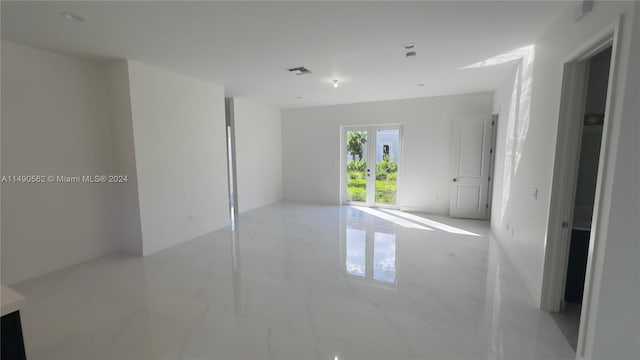 tiled spare room with french doors