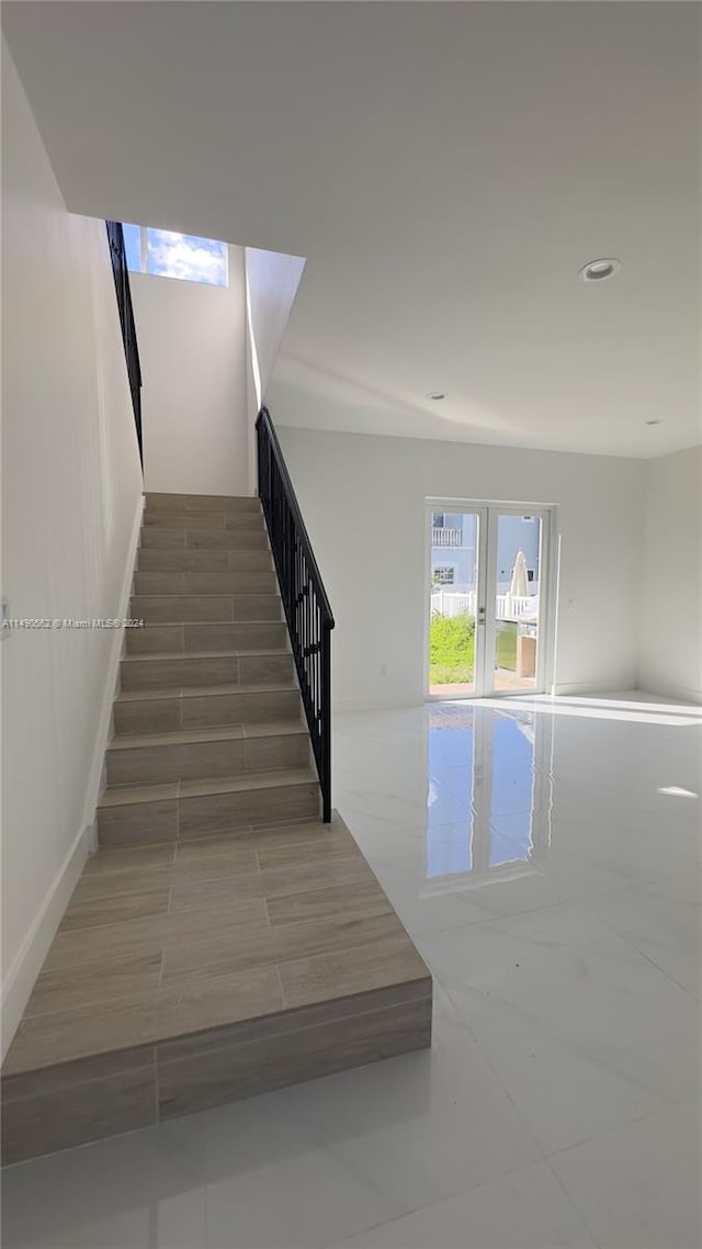 stairs featuring dark tile floors