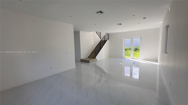 unfurnished room featuring light tile floors