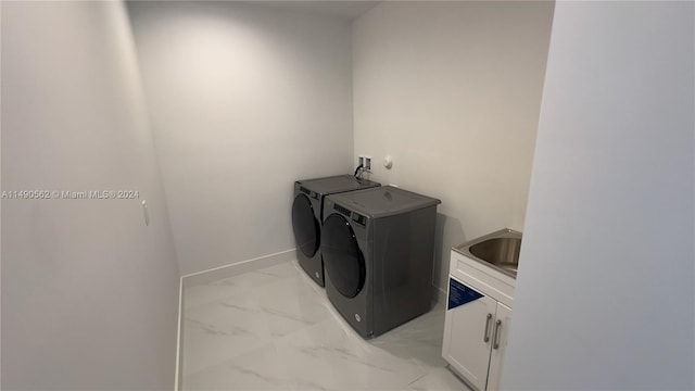 washroom with cabinets, sink, light tile floors, hookup for a washing machine, and independent washer and dryer