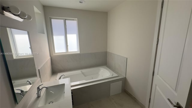 bathroom featuring tiled bath, tile floors, and vanity