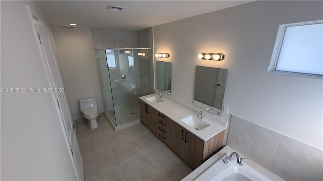 full bathroom featuring double sink, plus walk in shower, tile flooring, vanity with extensive cabinet space, and toilet