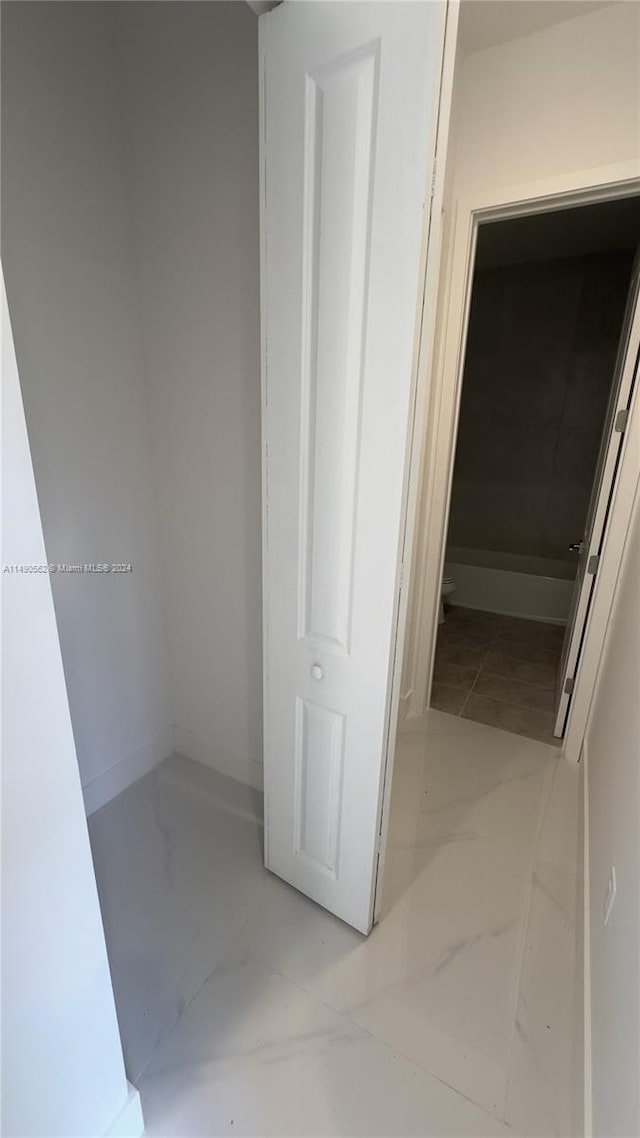 hallway with light tile floors