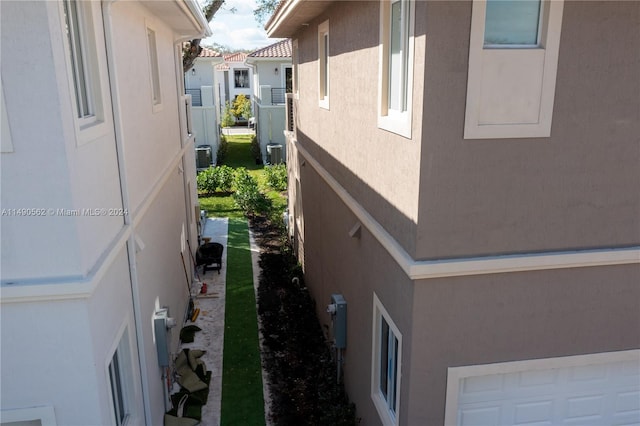 view of side of home featuring central AC