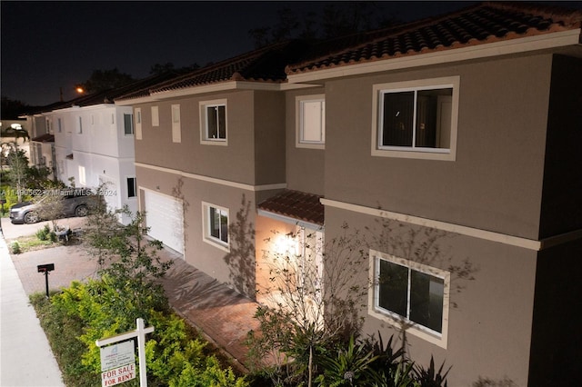 view of property exterior at night