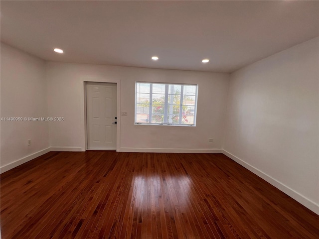 unfurnished room featuring dark wood-style floors, recessed lighting, and baseboards