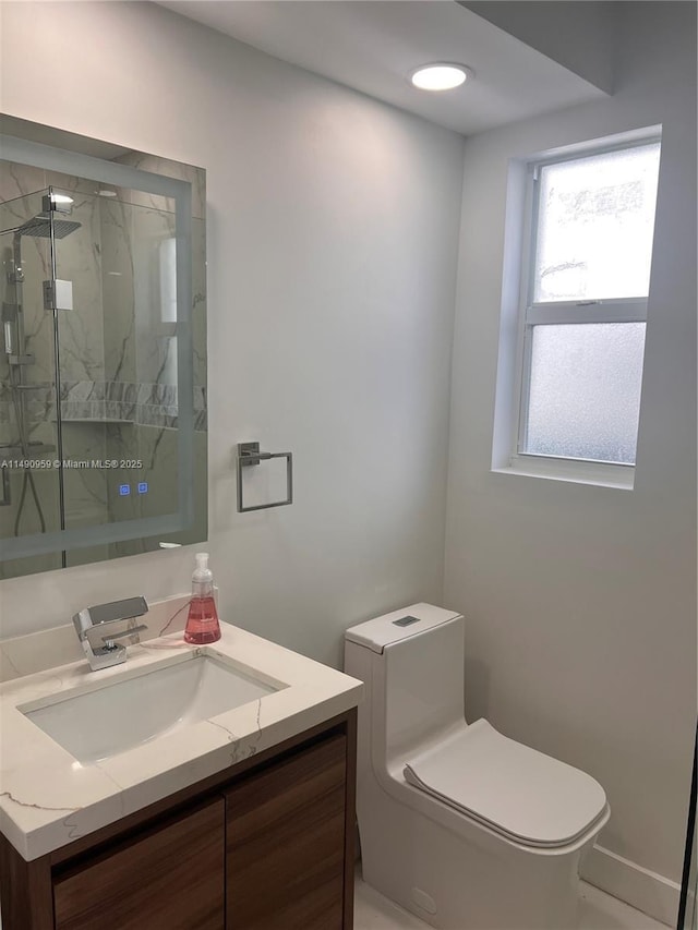 full bathroom with toilet, a marble finish shower, and vanity