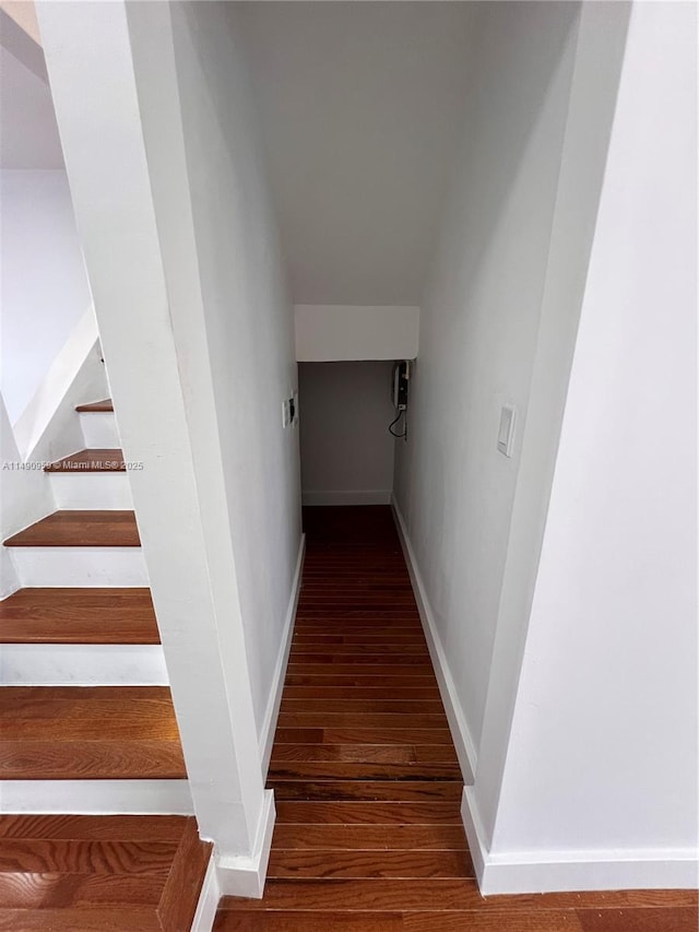 staircase with wood finished floors and baseboards