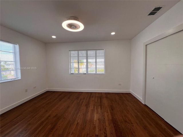 interior space featuring recessed lighting, visible vents, dark wood finished floors, and baseboards