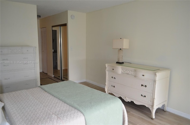 bedroom with a closet and light wood-type flooring