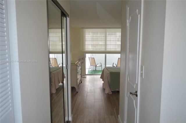 hallway with hardwood / wood-style floors