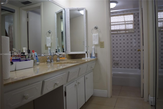 bathroom with shower / bath combination, tile floors, and vanity