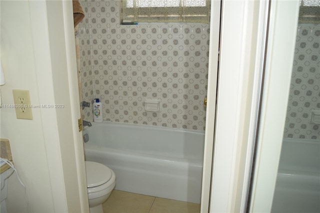 bathroom with toilet and tile floors