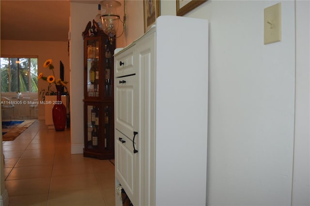 hallway featuring light tile floors