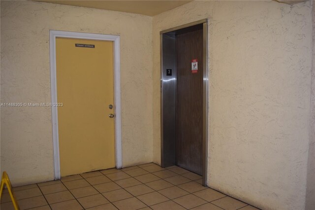 interior space featuring light tile floors and elevator