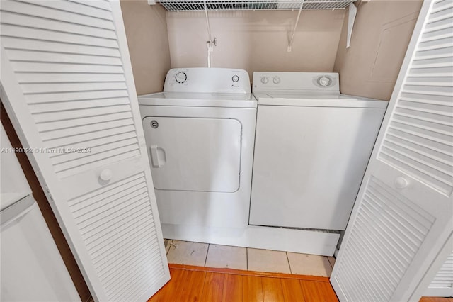 washroom featuring washer and dryer and light hardwood / wood-style flooring