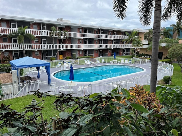 view of pool featuring a patio and a lawn