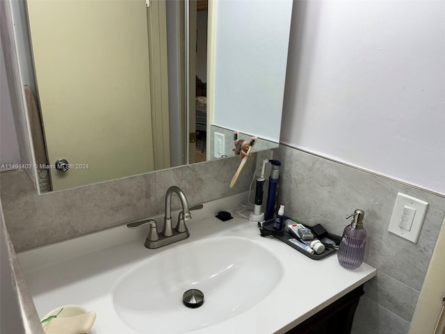 bathroom with tile walls and vanity