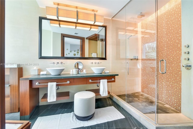 bathroom featuring double sink vanity, a shower with door, and tile floors