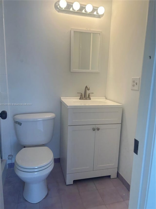 bathroom featuring toilet, tile floors, and large vanity