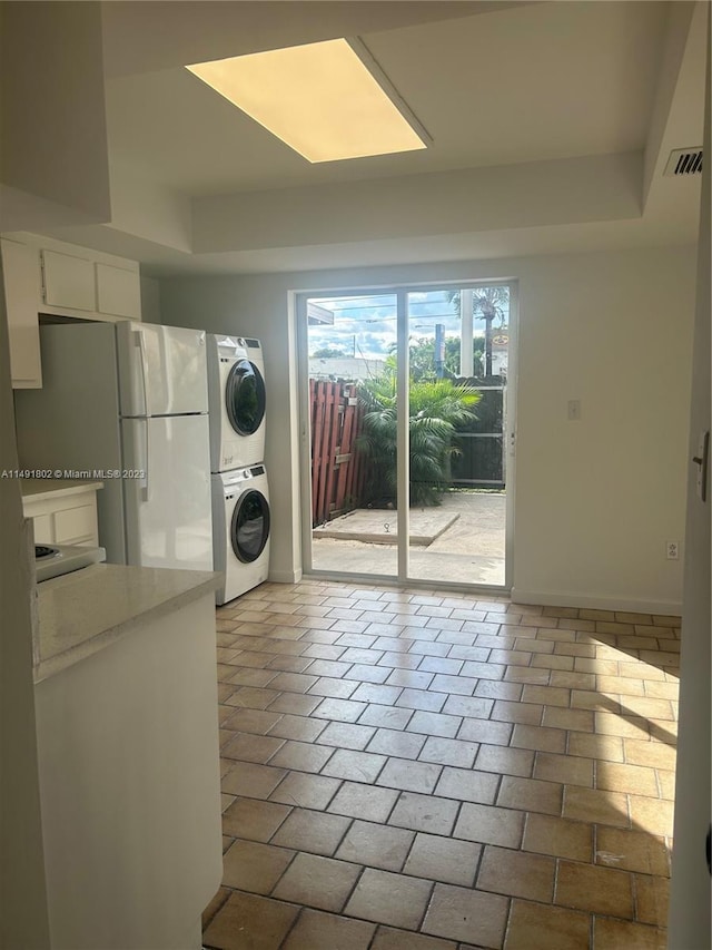 washroom with stacked washer and dryer