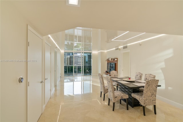 tiled dining room with expansive windows and a healthy amount of sunlight