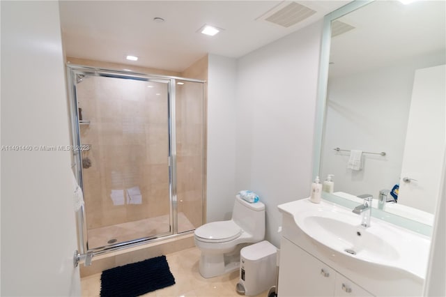 bathroom with an enclosed shower, toilet, tile floors, and vanity with extensive cabinet space