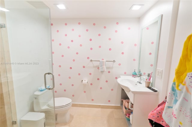 bathroom featuring a shower with door, tile flooring, and toilet