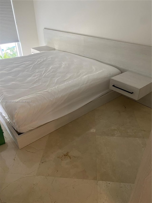 unfurnished bedroom featuring light tile floors