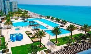 view of pool with a patio and a water view