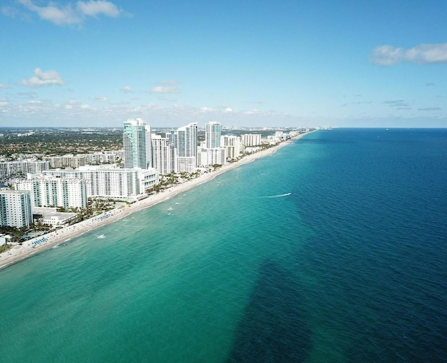 bird's eye view with a water view and a beach view