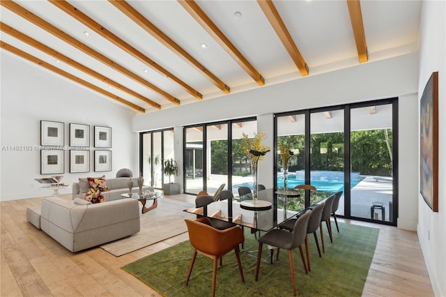 living room with beamed ceiling, high vaulted ceiling, and light hardwood / wood-style flooring