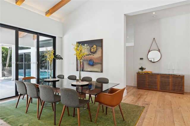 dining room with light hardwood / wood-style floors, french doors, and lofted ceiling with beams