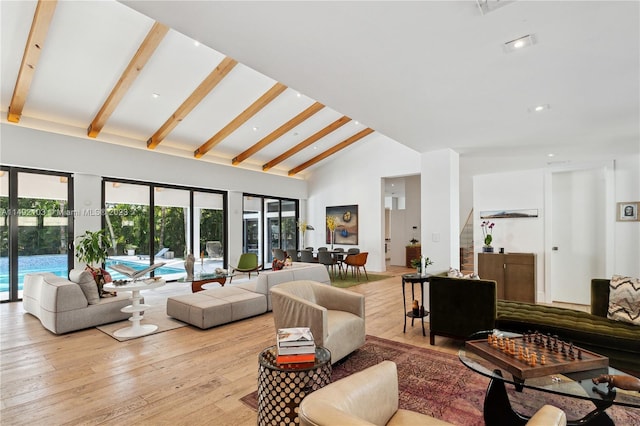 living room with high vaulted ceiling, beam ceiling, and light wood-type flooring