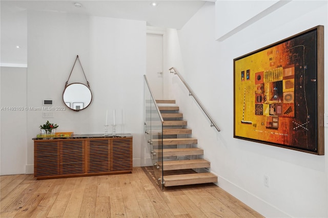 stairs featuring light hardwood / wood-style flooring