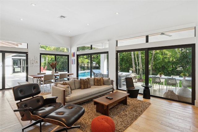 living room featuring ceiling fan and light wood-type flooring