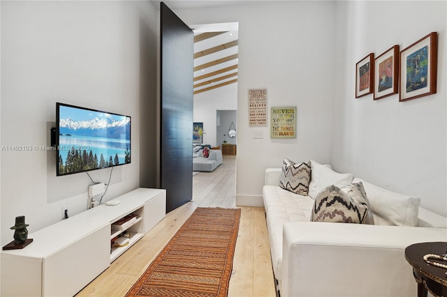 living room featuring vaulted ceiling and light wood-type flooring