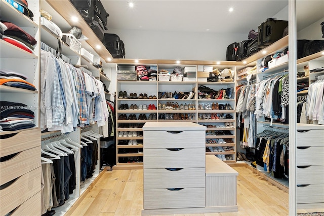 walk in closet with light hardwood / wood-style flooring