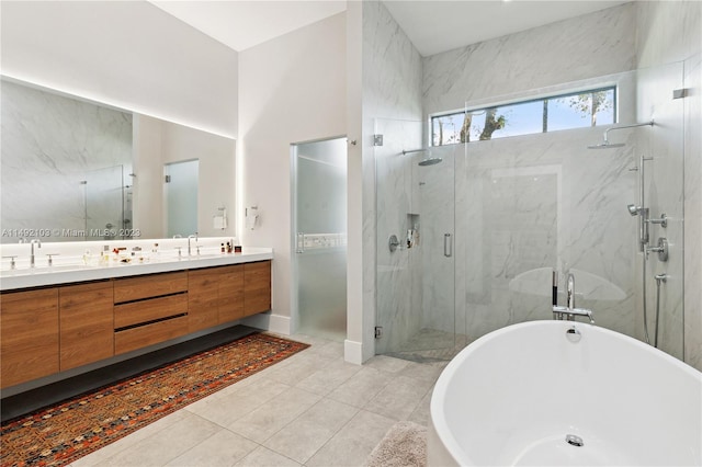 bathroom with large vanity, tile floors, plus walk in shower, and double sink