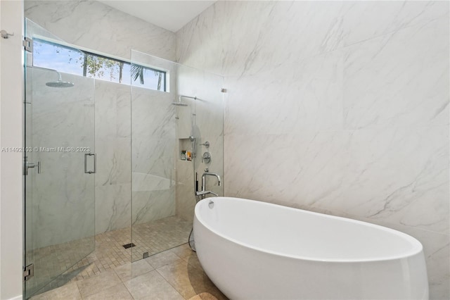 bathroom with independent shower and bath, tile walls, and tile flooring