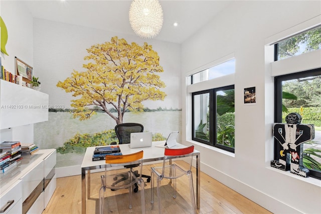 office featuring an inviting chandelier and light hardwood / wood-style floors