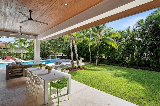 view of patio / terrace featuring ceiling fan and a fenced in pool