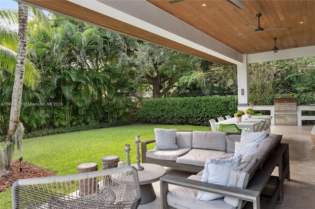 view of patio with exterior kitchen, outdoor lounge area, and a grill