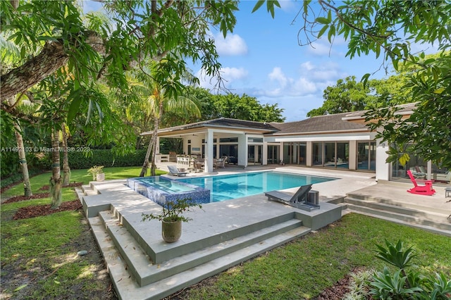 view of pool with a lawn and a patio