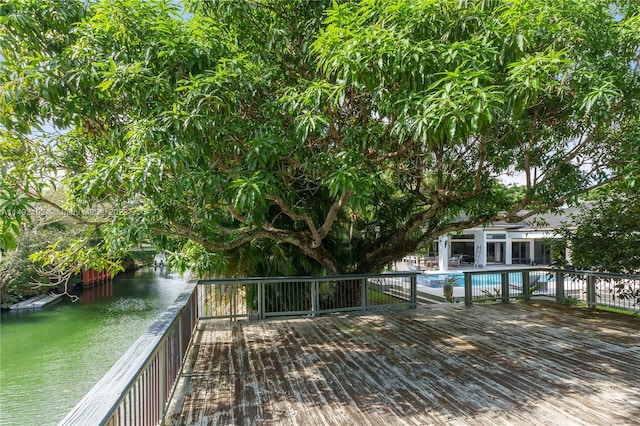 wooden terrace featuring a fenced in pool