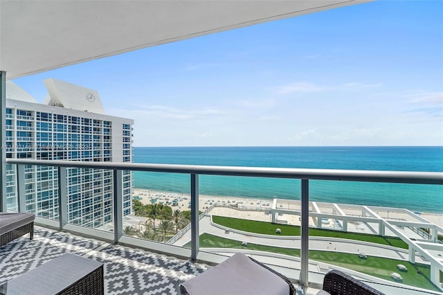 balcony with a beach view and a water view